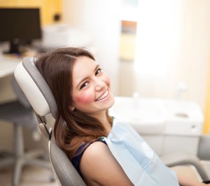 First visit of smiling woman in a exam chair